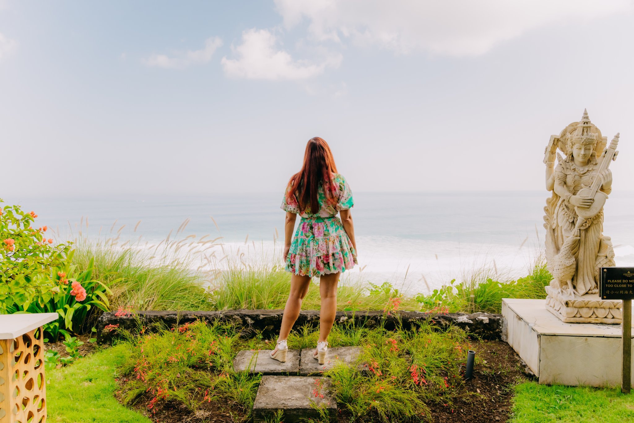 Laura looking toward the ocean from a tropical garden in Bali