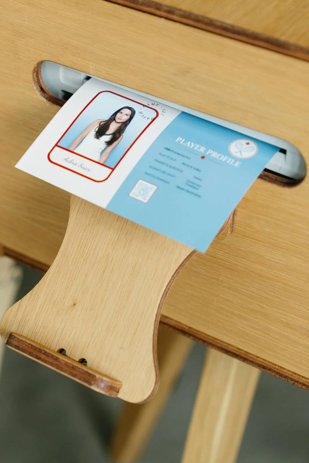 Custom player trading card printing from a wooden photo booth printer slot