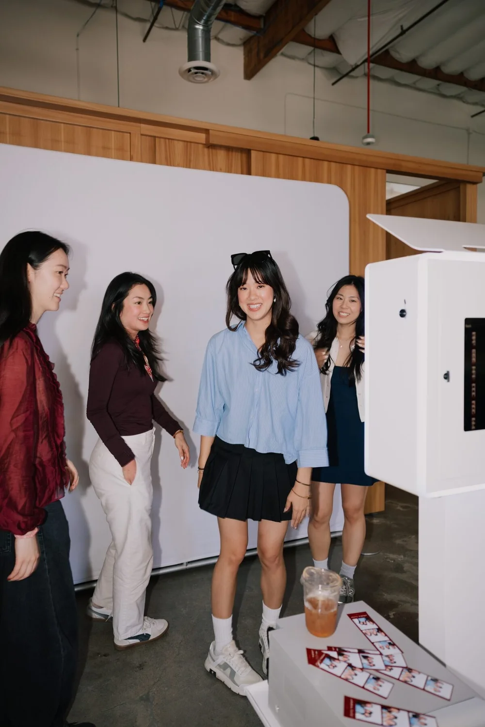Guests laughing at the open-air photo booth at the Cherry Golf Club and Ever Club collaboration in Tustin