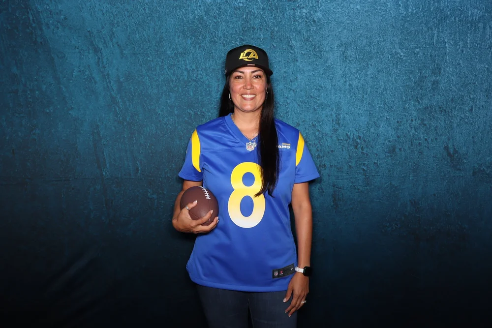 A member in a Rams number 8 jersey at the sponsor's member night photo booth