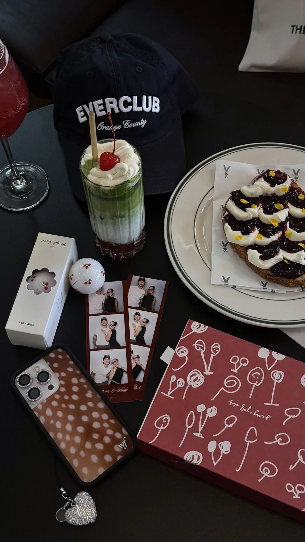 Ever Club hat, Cherry Golf Club merch, matcha and photo booth strips at the collaboration in Tustin