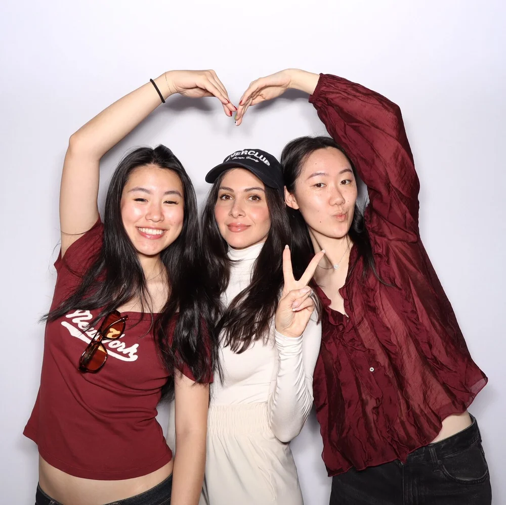 Three friends making a heart on the Cherry Golf Club and Ever Club photo booth