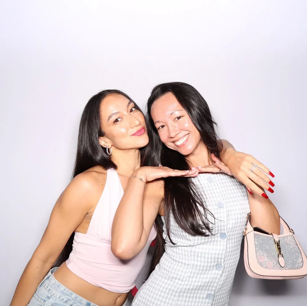 Two guests smiling in the photo booth at the Cherry Golf Club collaboration