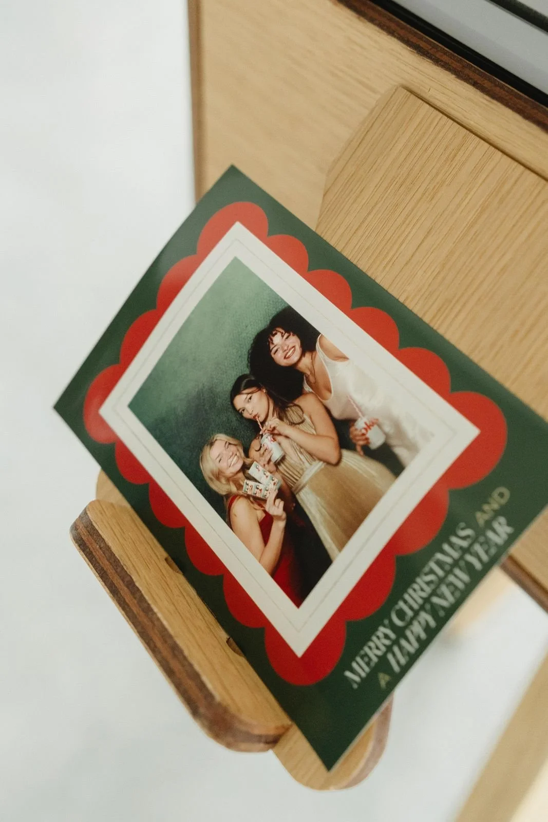 Merry Christmas photo print resting on a wooden photo booth at a holiday party