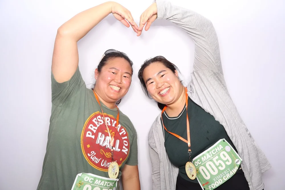 Two guests making a heart with their arms in the photo booth