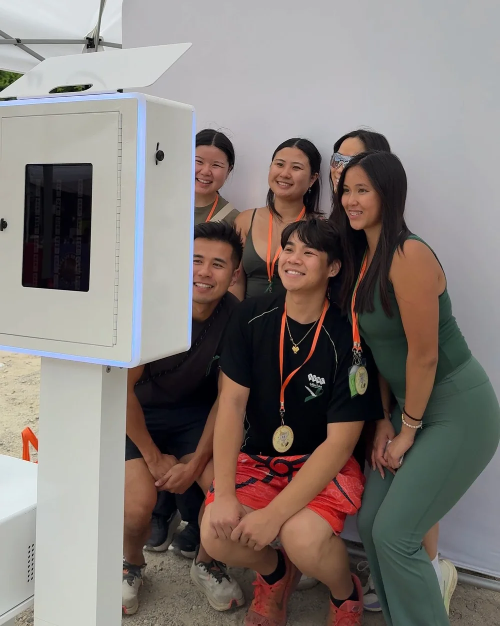 A group of crawlers with medals posing at the open-air photo booth in Old-Towne Tustin