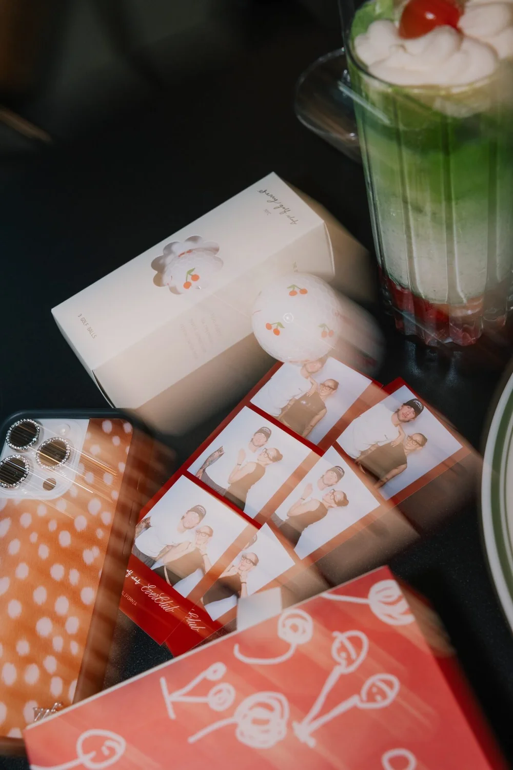 Co-branded Cherry Golf Club and Ever Club photo strips with cherry golf balls and merch