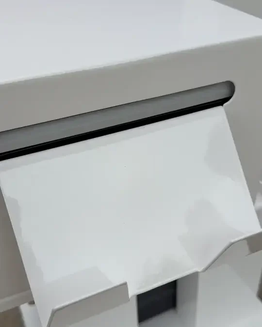 A co-branded photo strip printing out of the open-air booth