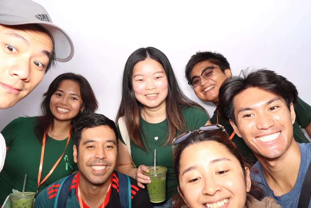 A group of friends with matcha and medals in the photo booth at the OC Matcha Food Crawl in Old-Towne Tustin