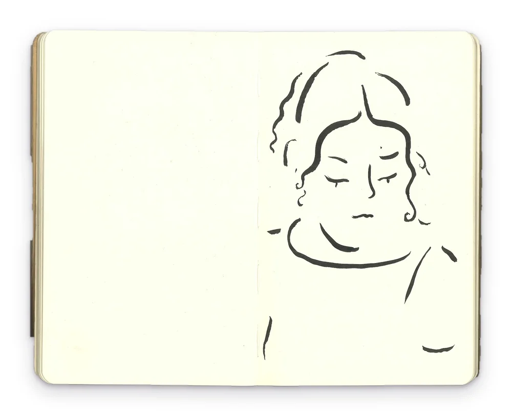 Ink portrait of a woman with curly hair and lowered eyes, drawn across a sketchbook spread