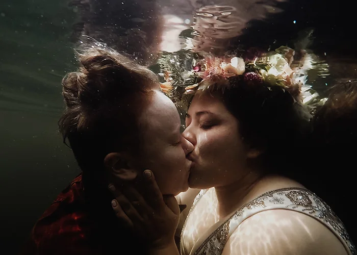 newlywed couple kissing underwater