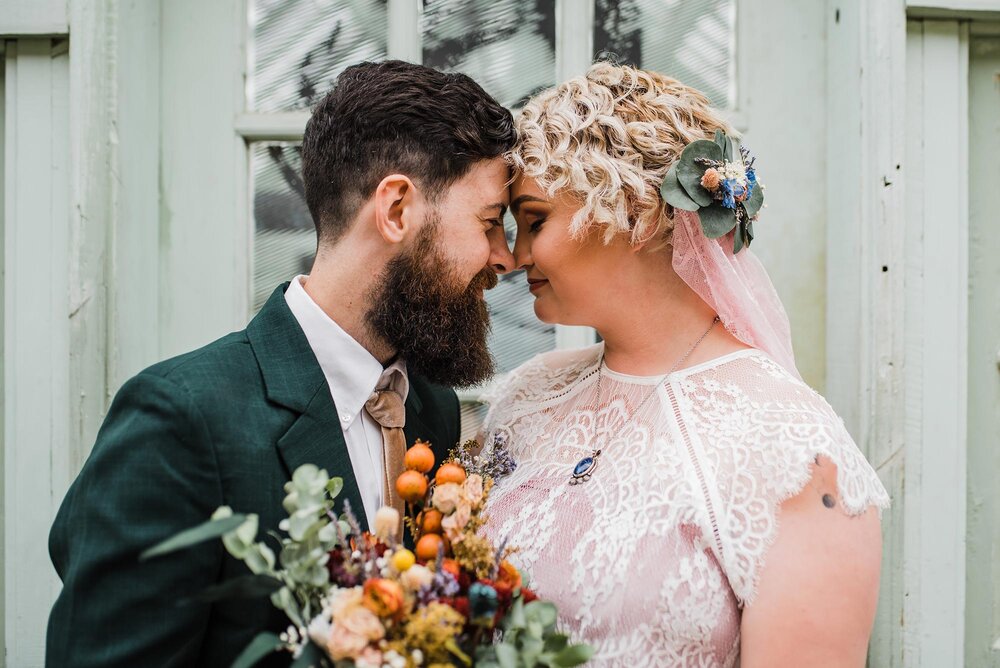 newlywed couple touching noses after autumn wedding philadelphia