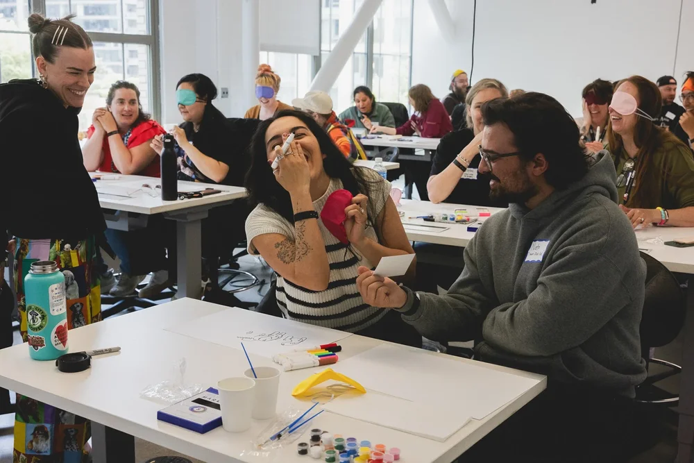 A team laughing during a workshop