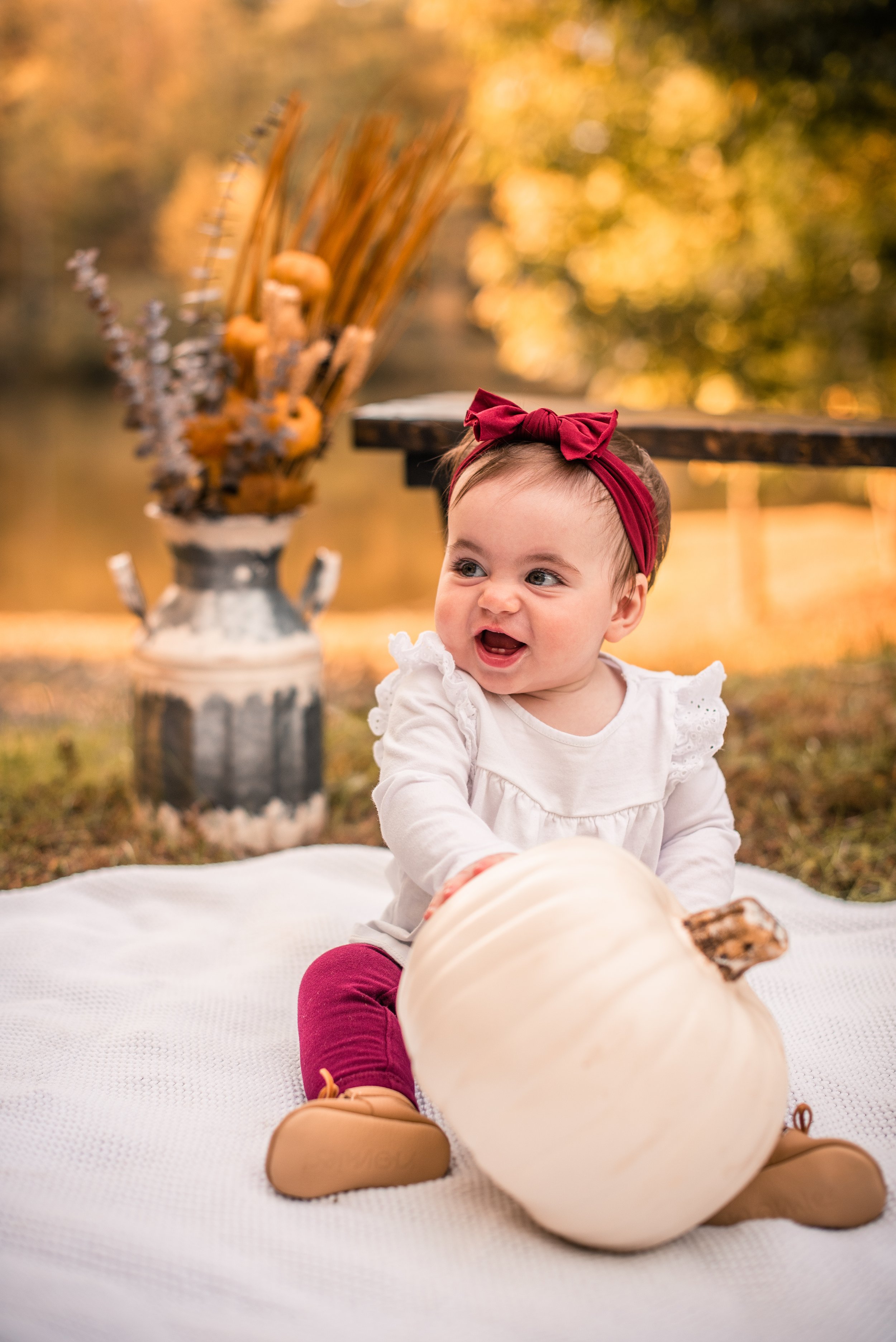 Baby girl with a fall pumpkin during a Burlington, NC mini session