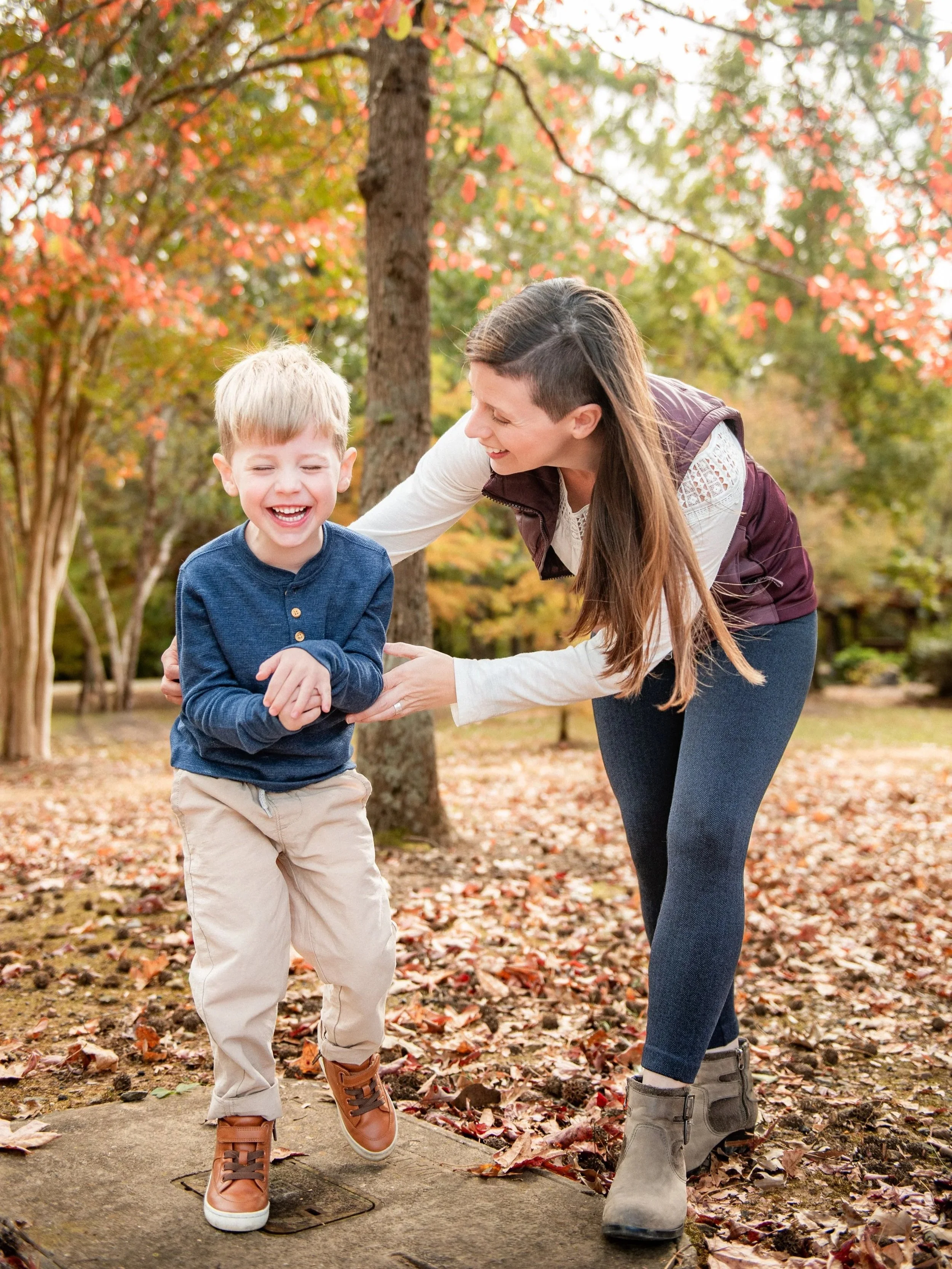 Mother and son laughing together during a fall mini session in Burlington, NC