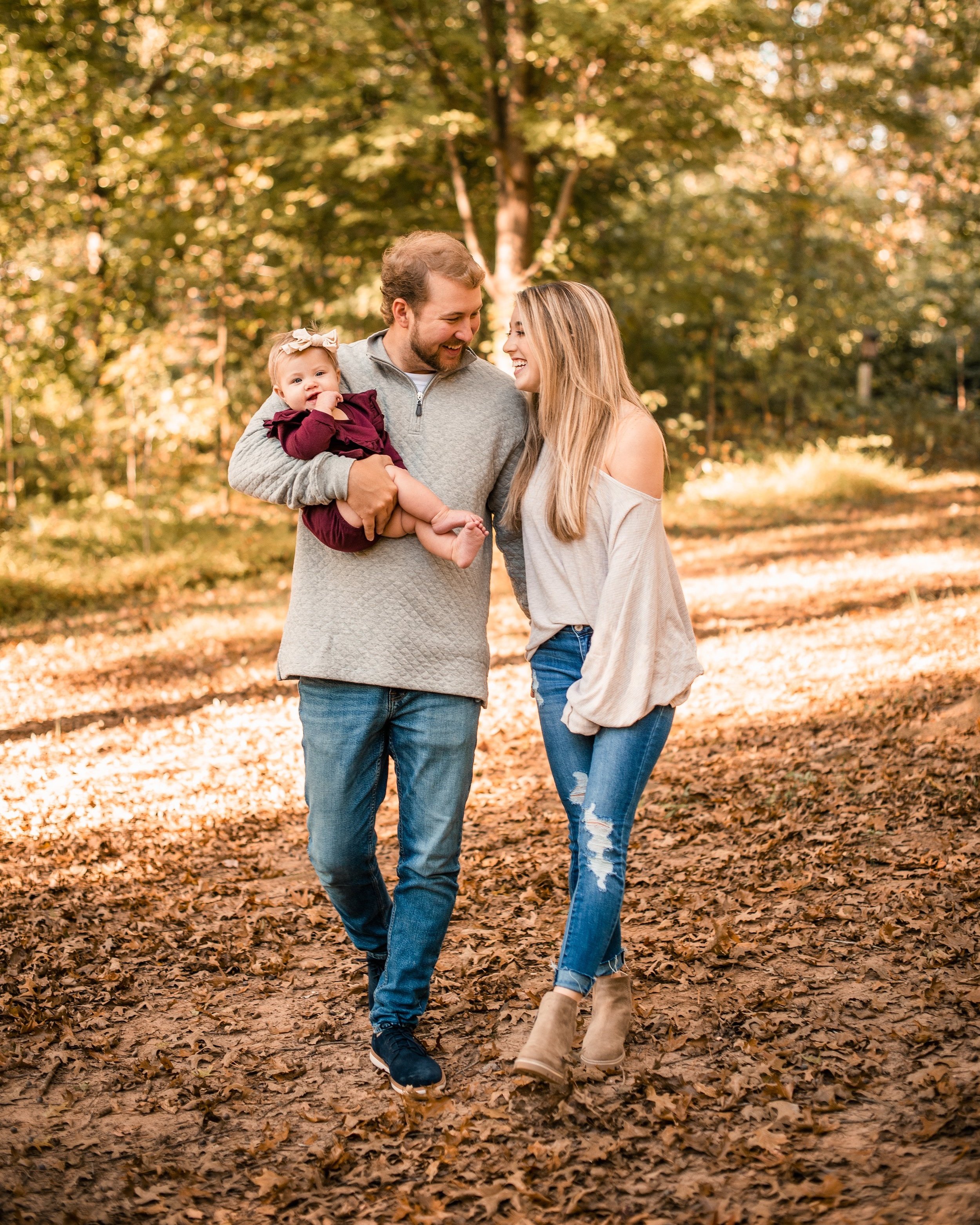 Family walking together on a golden fall path in Burlington, NC