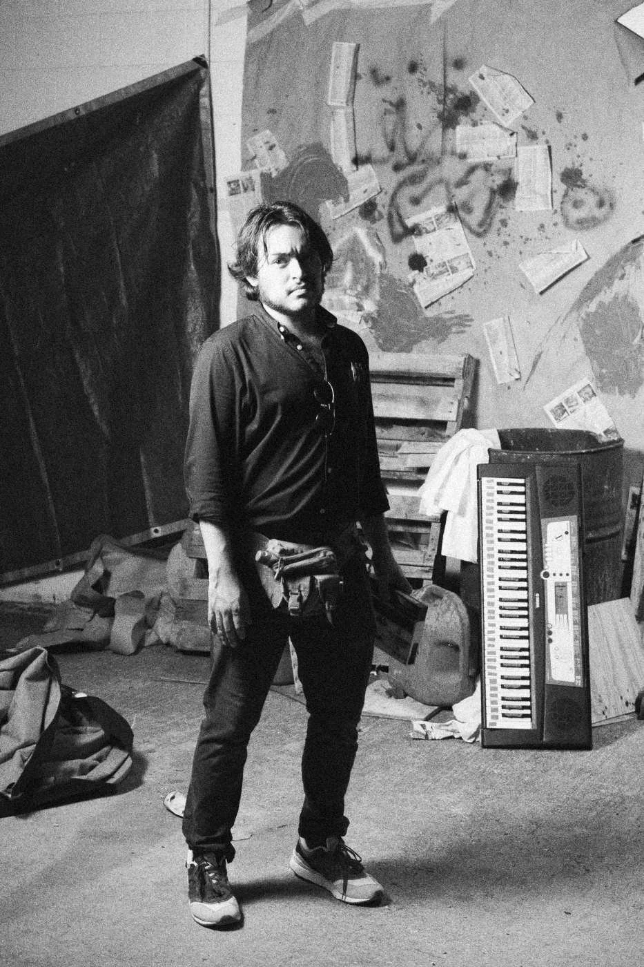 Behind the scenes on INERTIA: a crew member standing in front of the graffiti set.