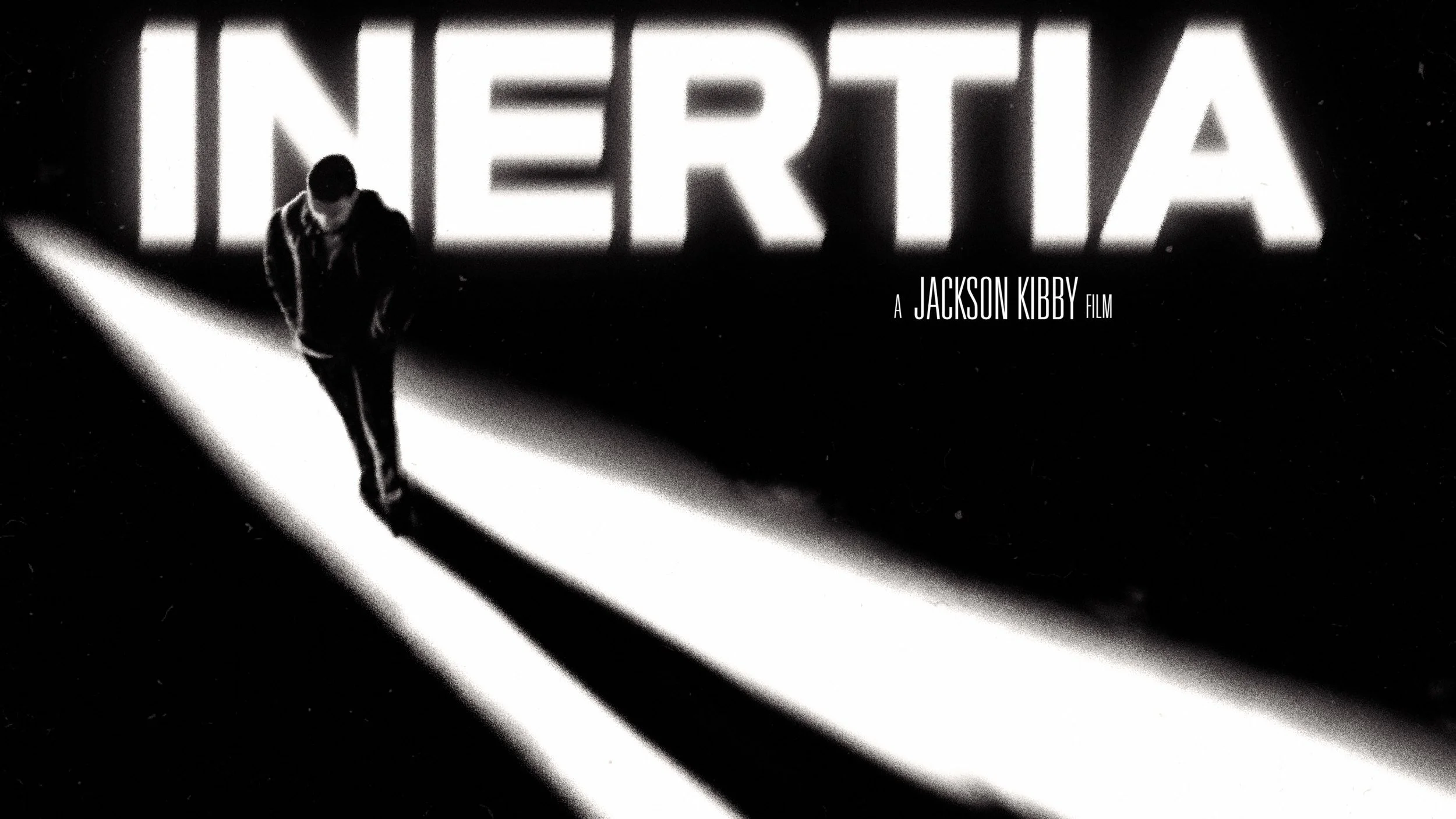 INERTIA key art: the title in glowing white letters above a lone figure walking through a hard diagonal beam of light, casting a long shadow. A Jackson Kibby film.