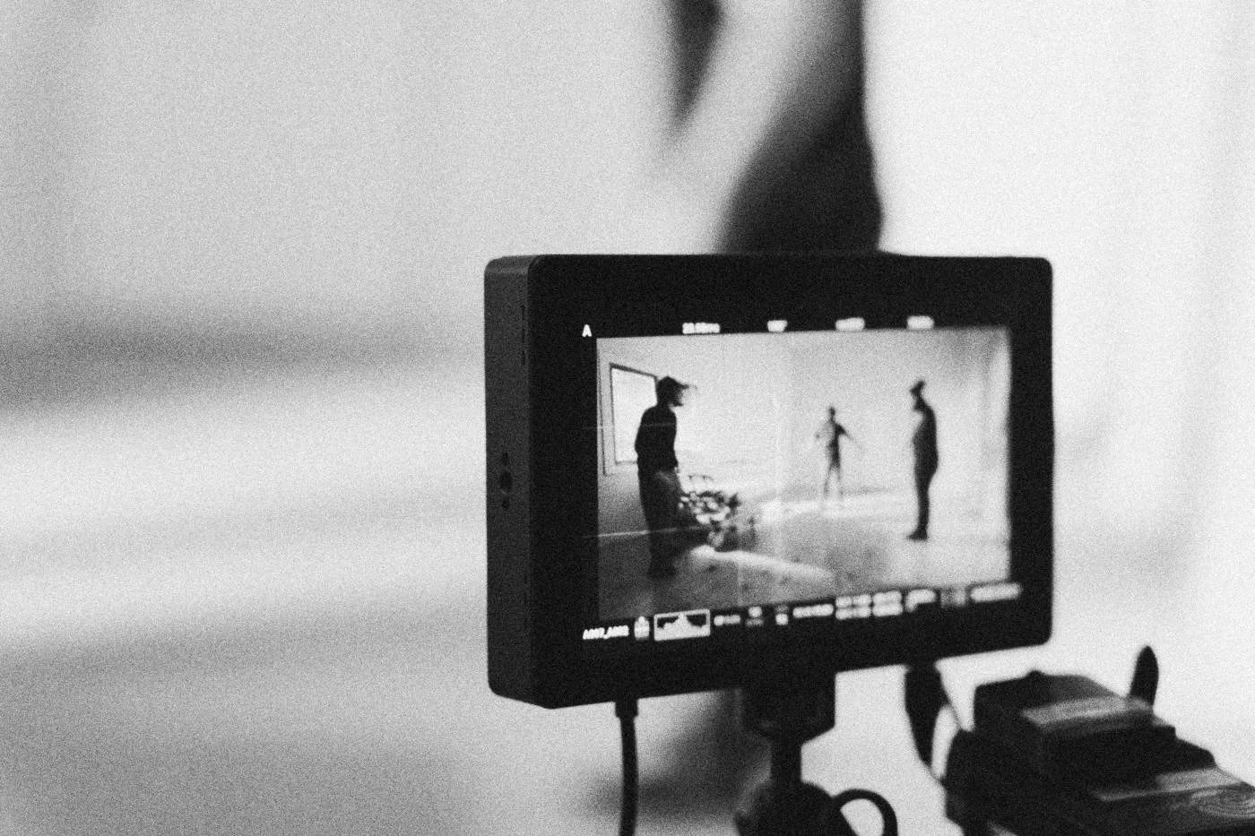 Behind the scenes on INERTIA: a field monitor showing the scene sits sharp in the foreground against a blurred set.