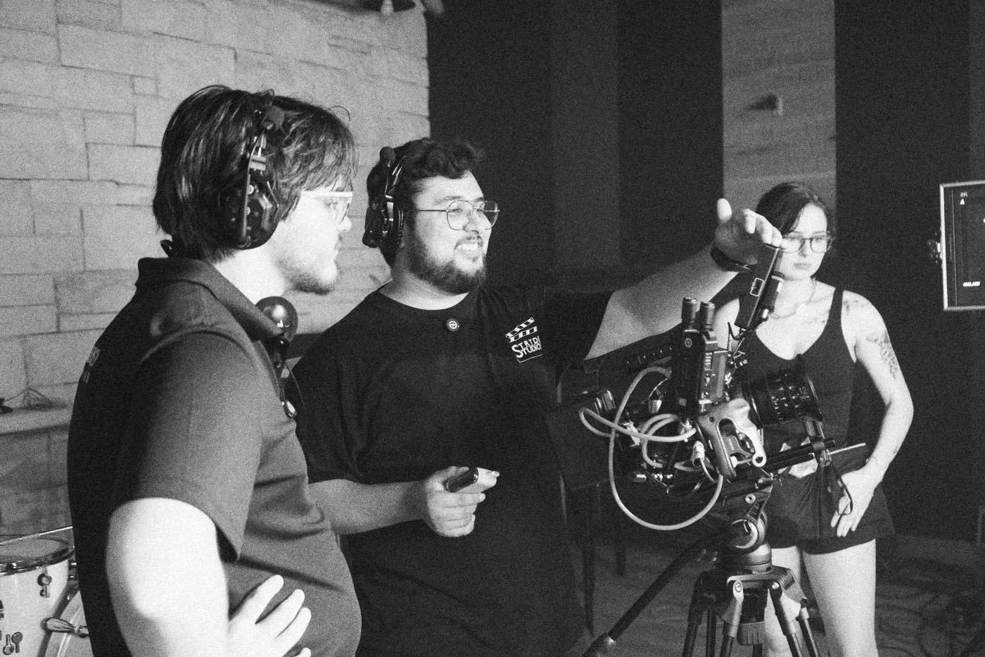 Behind the scenes on INERTIA: two crew members laugh at a camera rig while an actress watches.