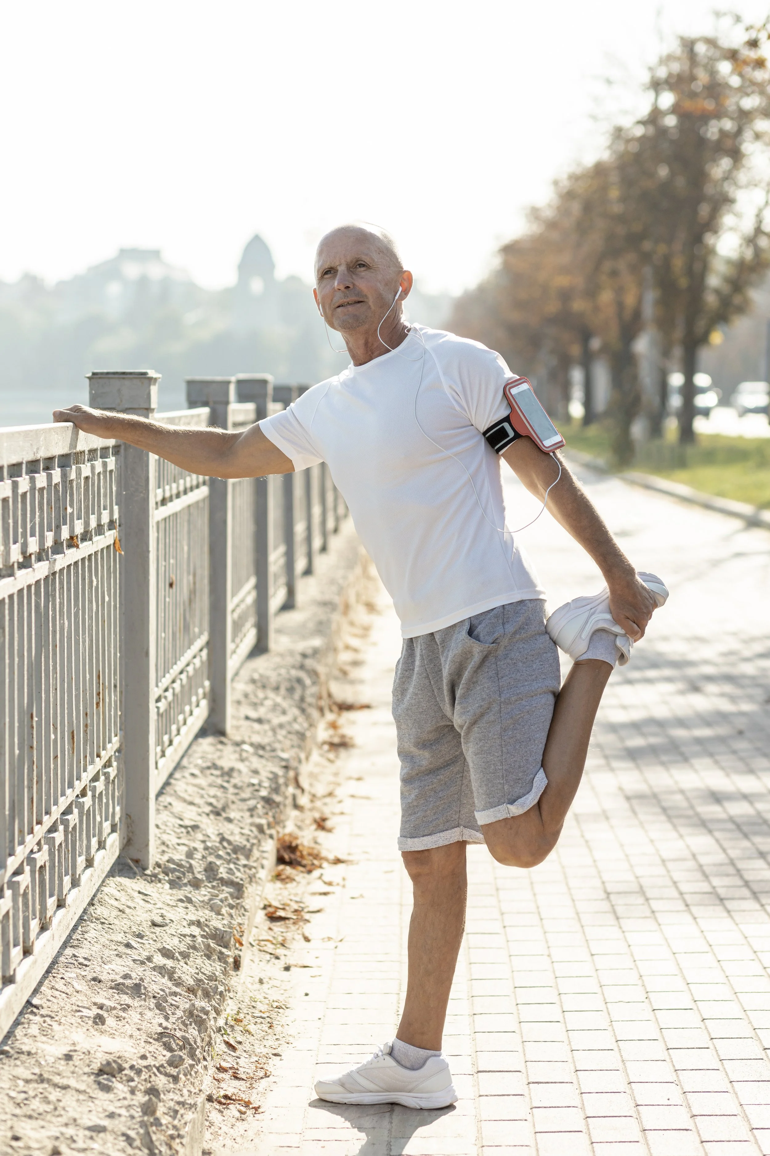Older male runner stretching — longevity and healthspan