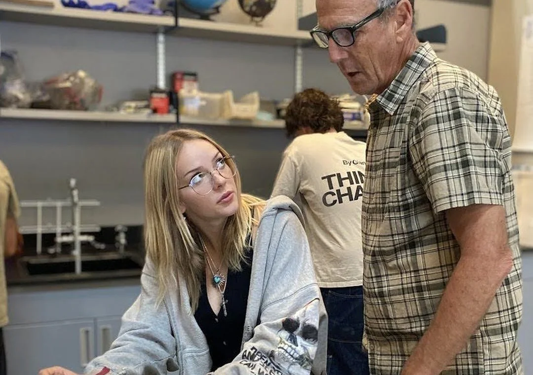 A teacher working with a student in the science lab