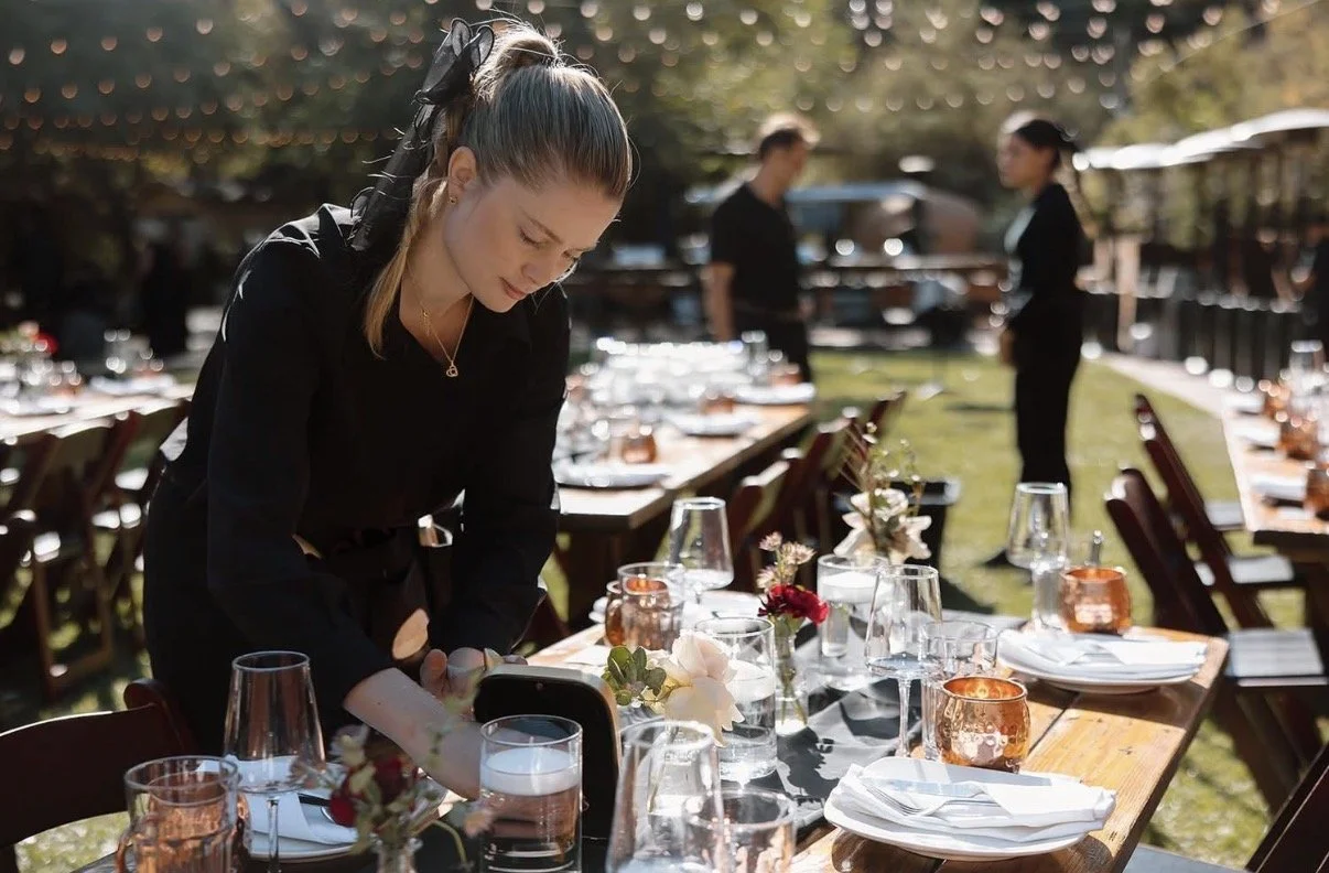 Allison H., lead event planner at Platinum Bartenders, setting a wedding table in Los Angeles