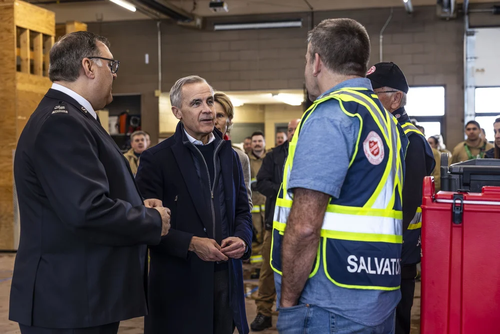 Prime Minister Mark Carney speaking with a Salvation Army officer