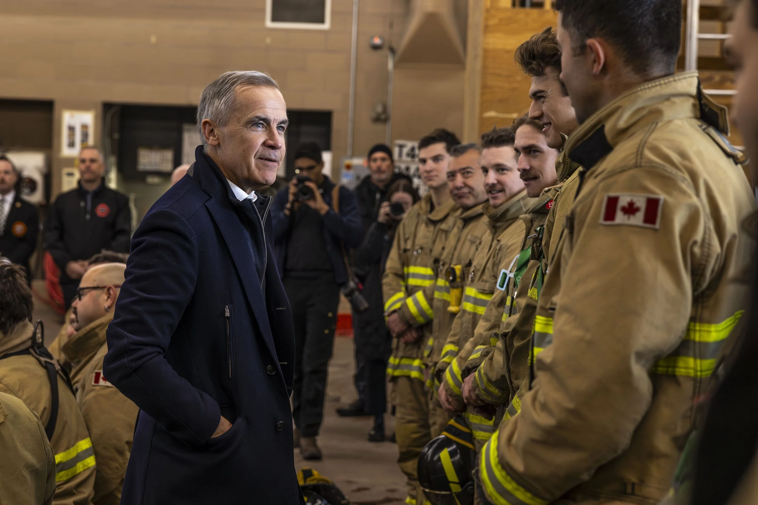 Prime Minister Mark Carney speaking with firefighters
