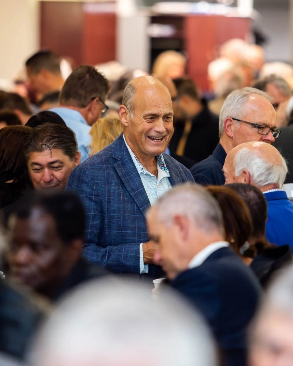 Guest laughing with others in the crowd at the Ottawa Civic Prayer Breakfast