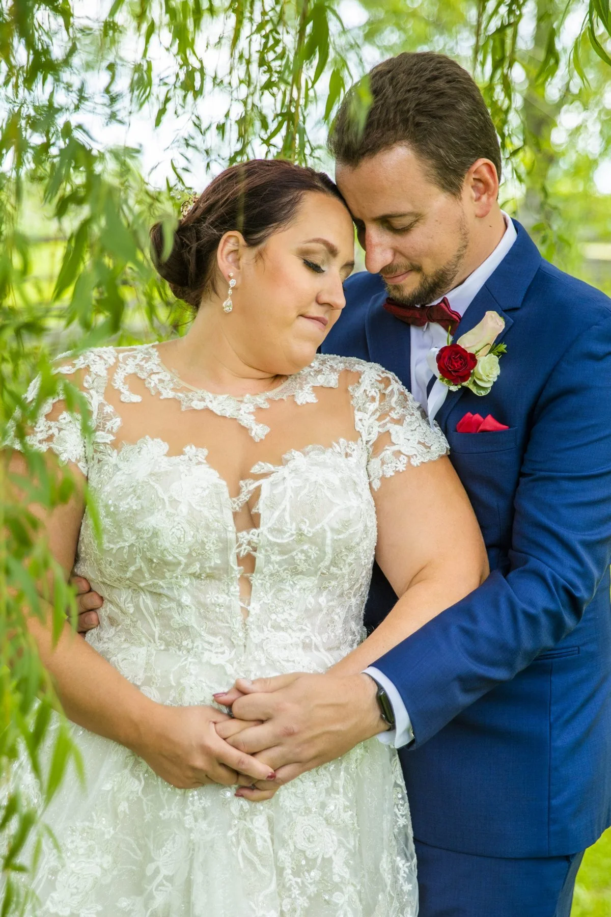 Groom holding the bride close from behind