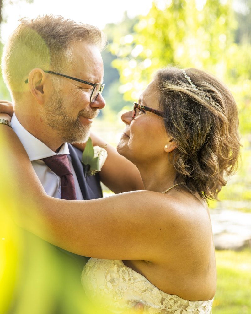 Bride and groom smiling in a close embrace