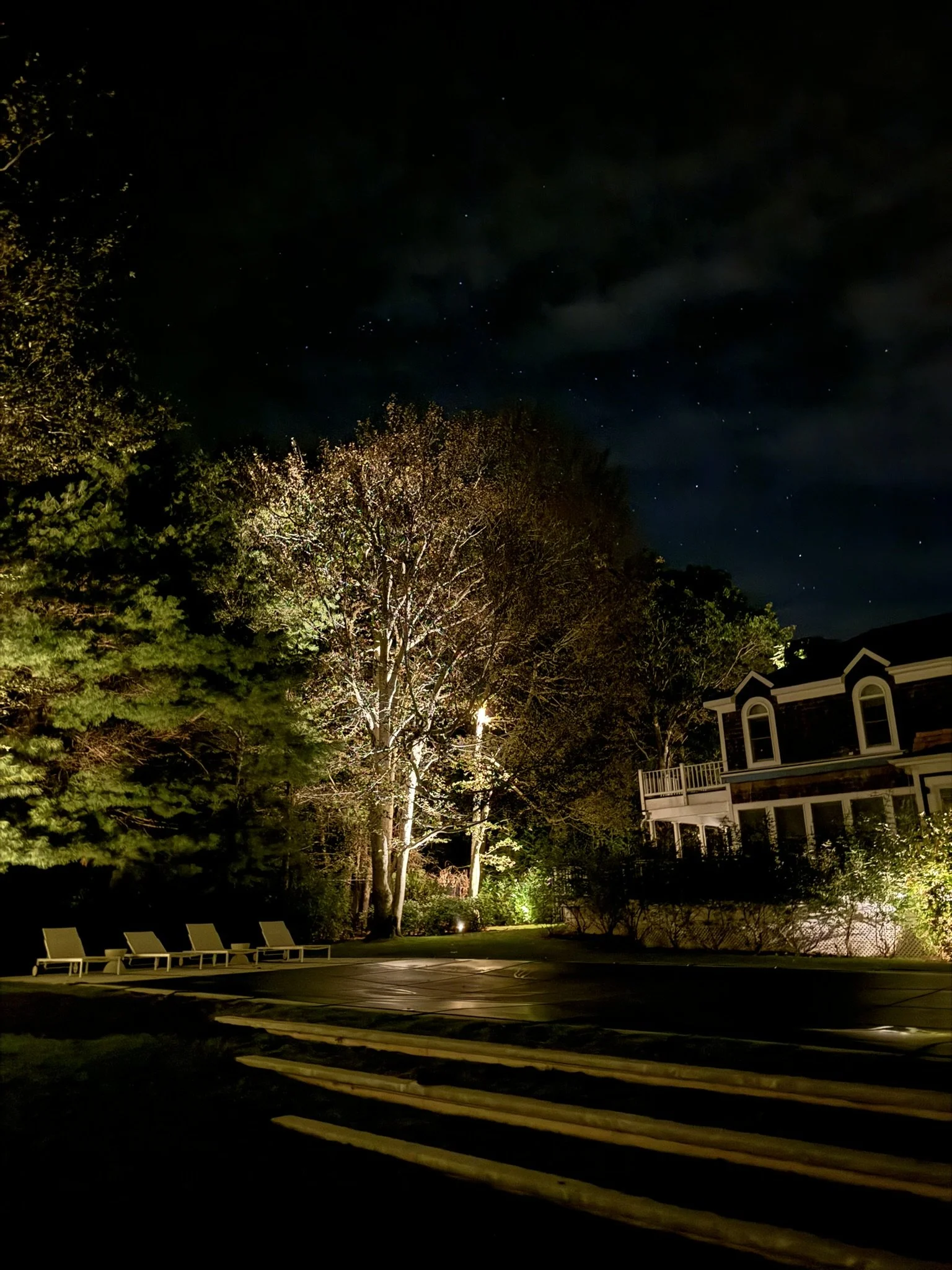 Luxury home backyard illuminated at night