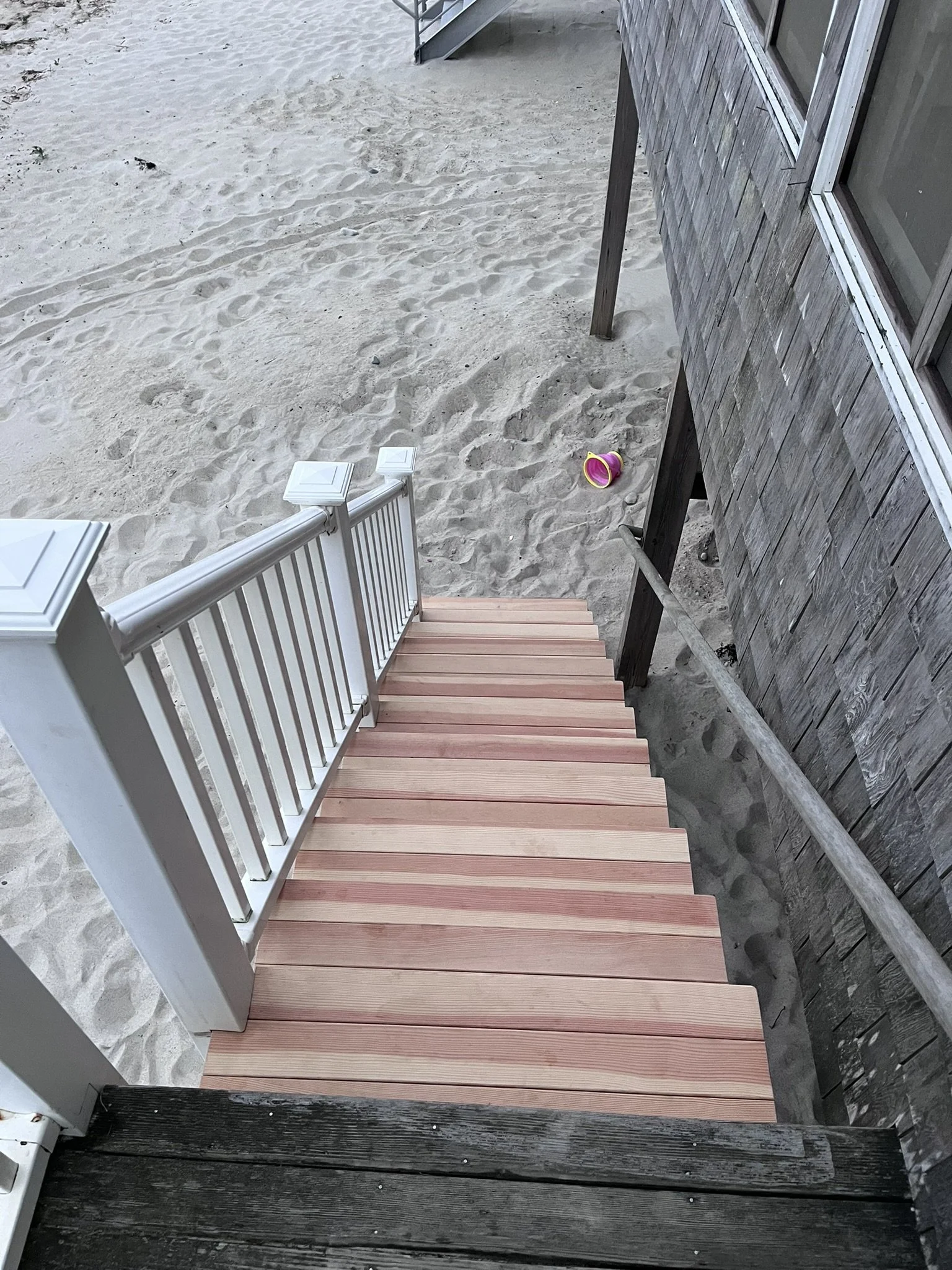 Looking down the stairs toward the beach from the top deck