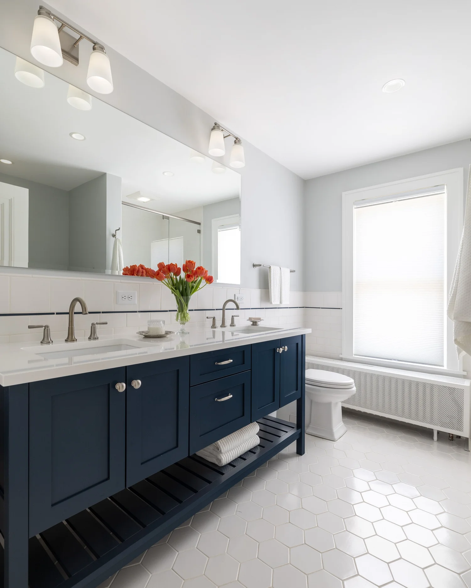 Expanded hall bathroom with navy double vanity
