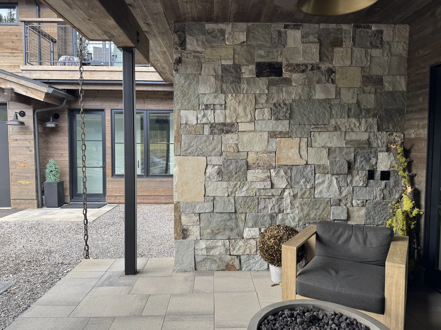 Canyon River full veneer in split and natural faces across a mountain-home facade.