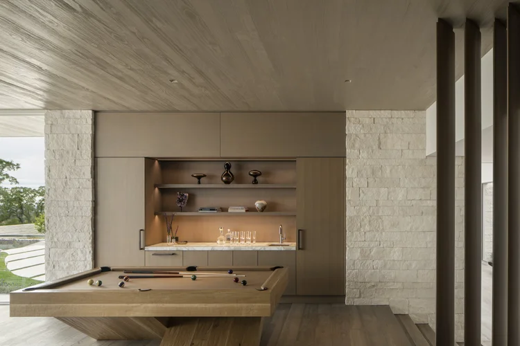 White coursed veneer with dry-stack joints on an interior wall.