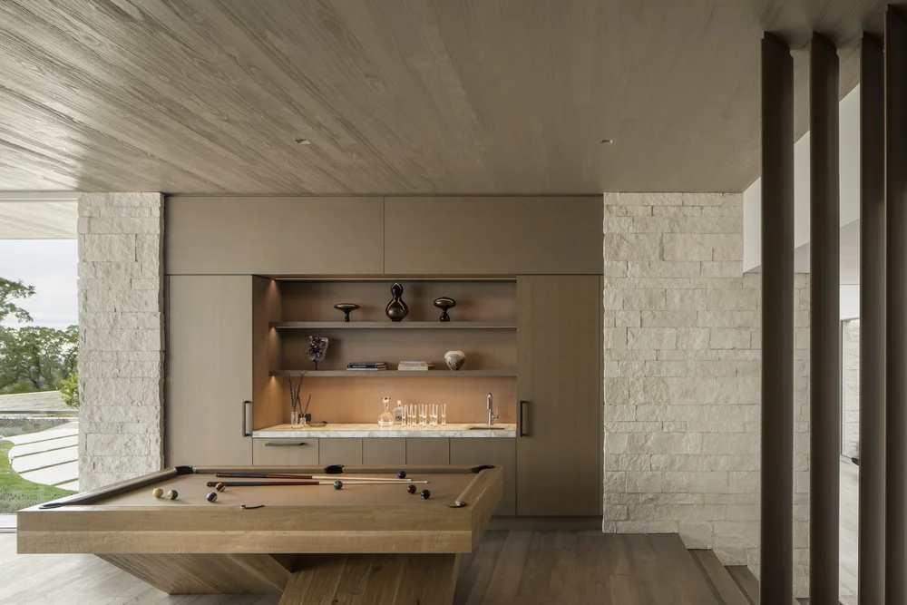 White coursed veneer with dry-stack joints on an interior wall.