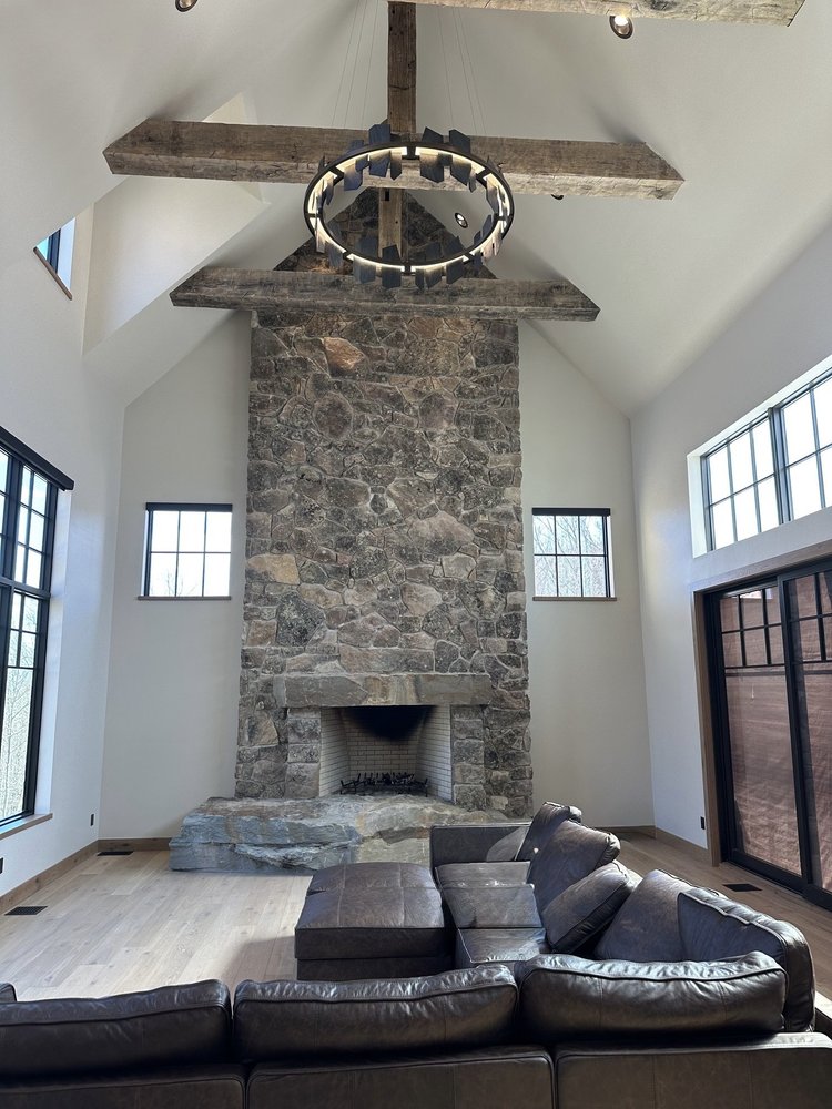 Montana Moss mosaic veneer in split face rising up an interior fireplace.