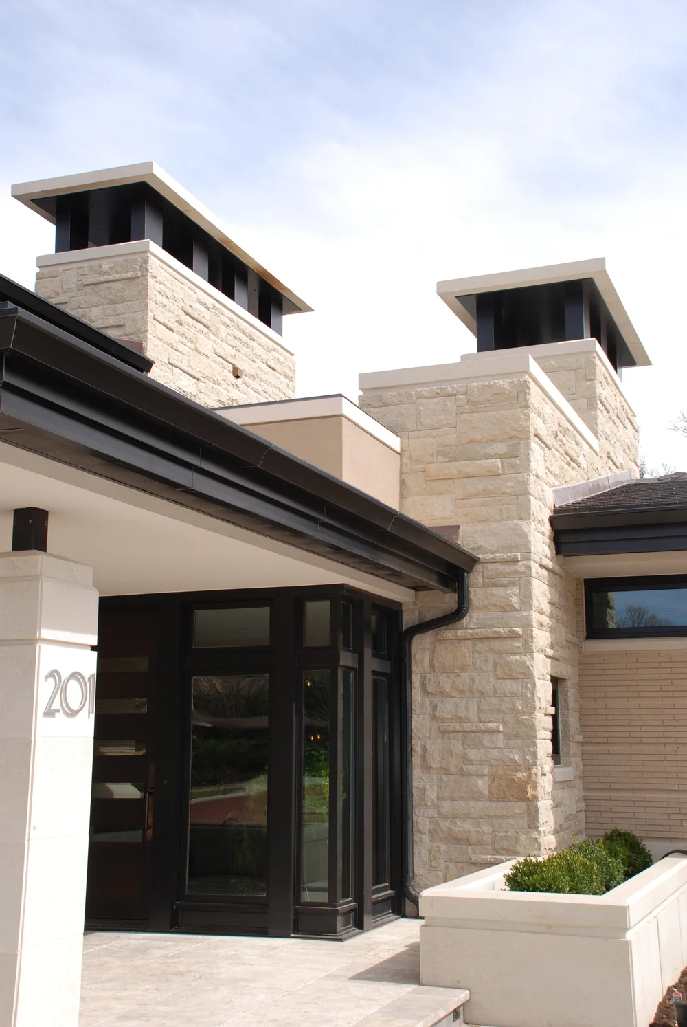 Prairie Shell split-face ashlar veneer rising up a tall facade.