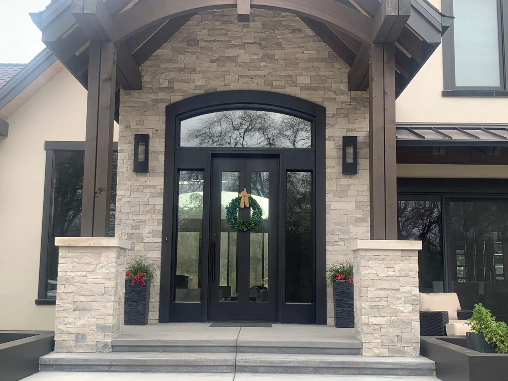 Mayville piers carry a heavy timber entry porch, Indiana Limestone caps finishing the flanking piers.