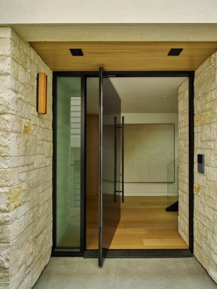 Sea Fossil ashlar veneer with flush joints and a honed Cream lintel at a facade entry.