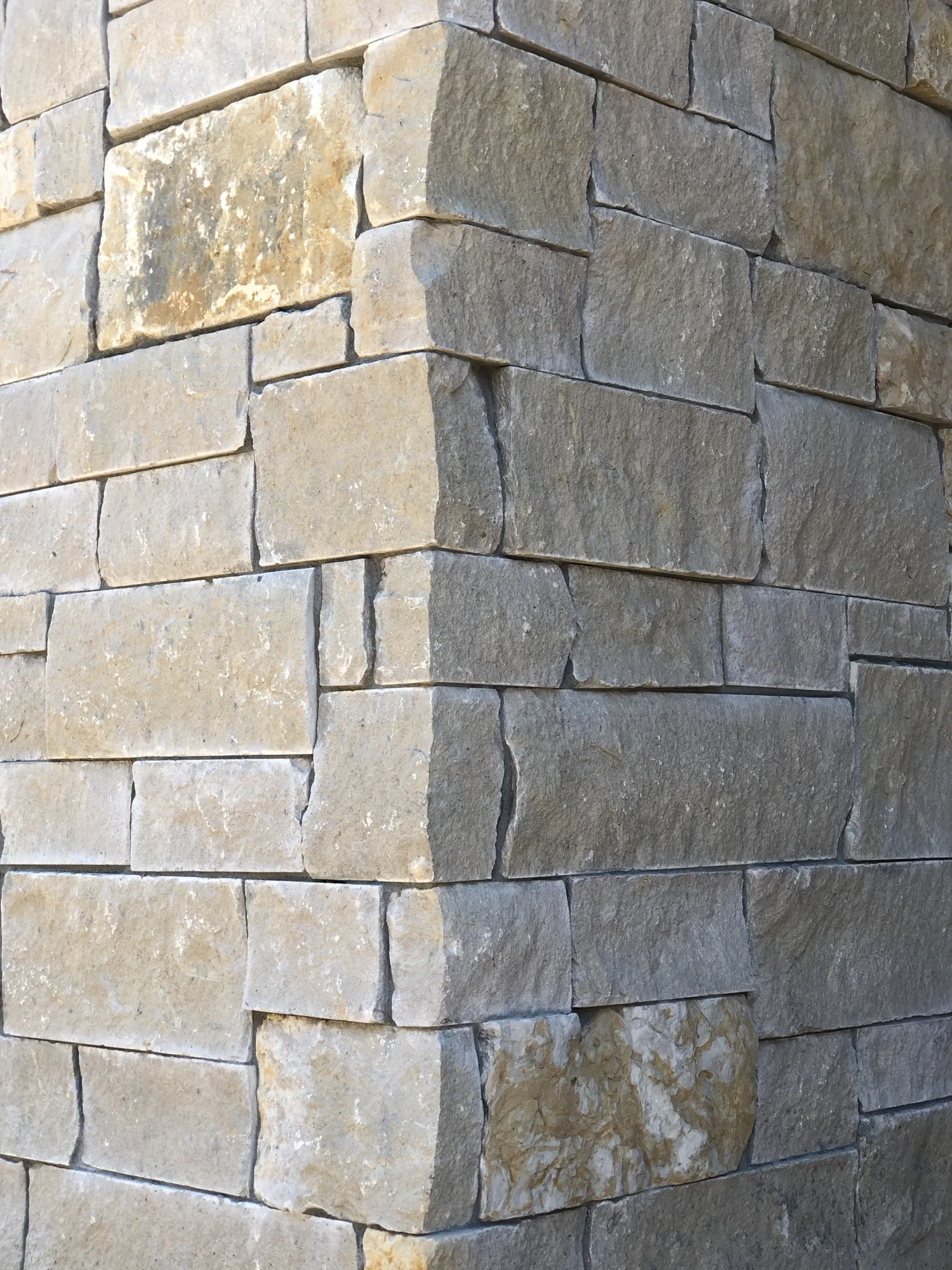 Buff ashlar veneer in split and natural faces, a stacked material sample.