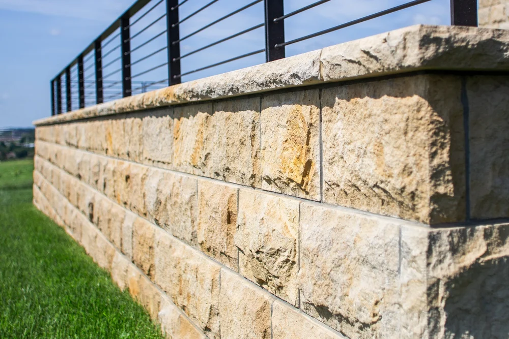 Split-face Onaga veneer topped with honed Onaga wall caps.