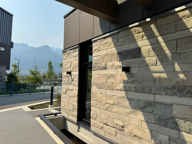 Split-faced Charcoal coursed veneer with raked joints on a facade.