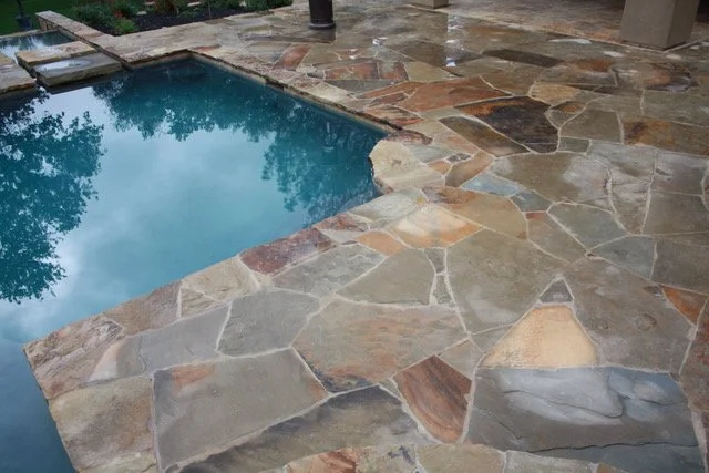 Desert Mountain irregular pavers in a natural finish surrounding a pool.