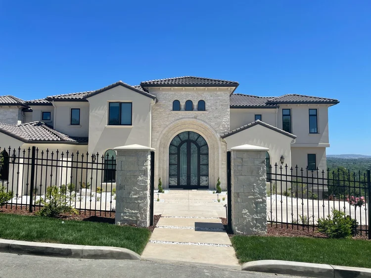 Sea Fossil ashlar veneer in split and natural faces with dry-stack joints across a facade and entry.