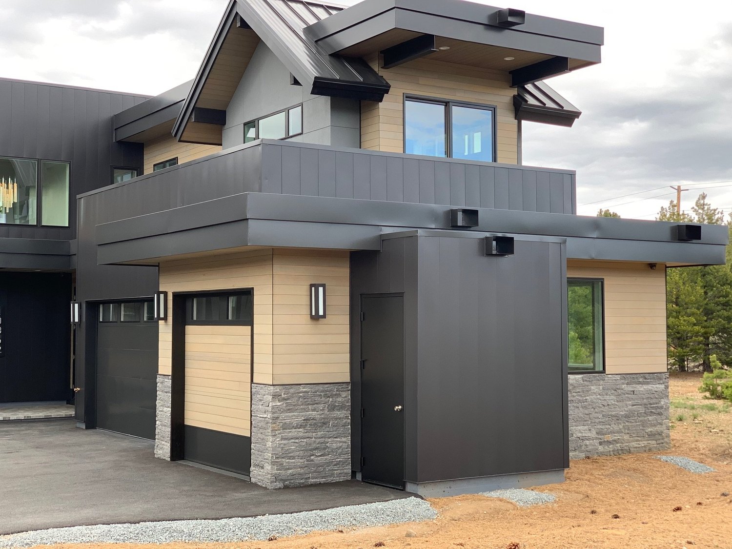 Silver Pearl carries around the garage wing, a gray base under tan siding and dark trim.