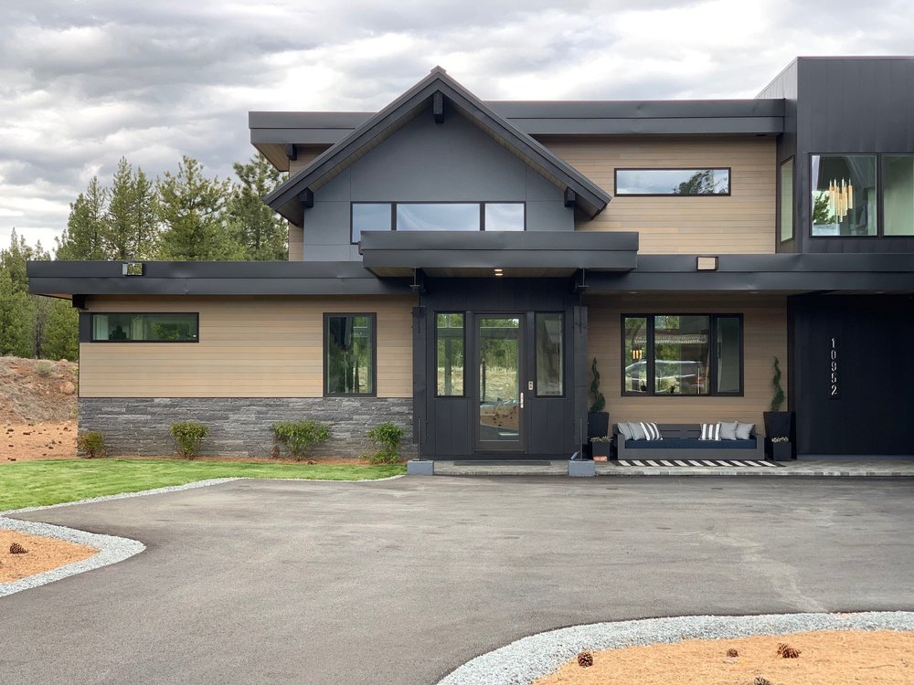 Silver Pearl runs a low band beneath the entry of a gabled mountain house in tan siding.