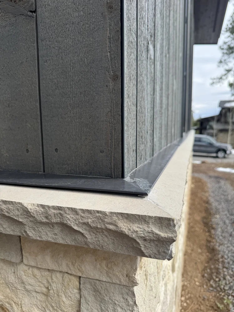 Buff wainscot caps on a facade.
